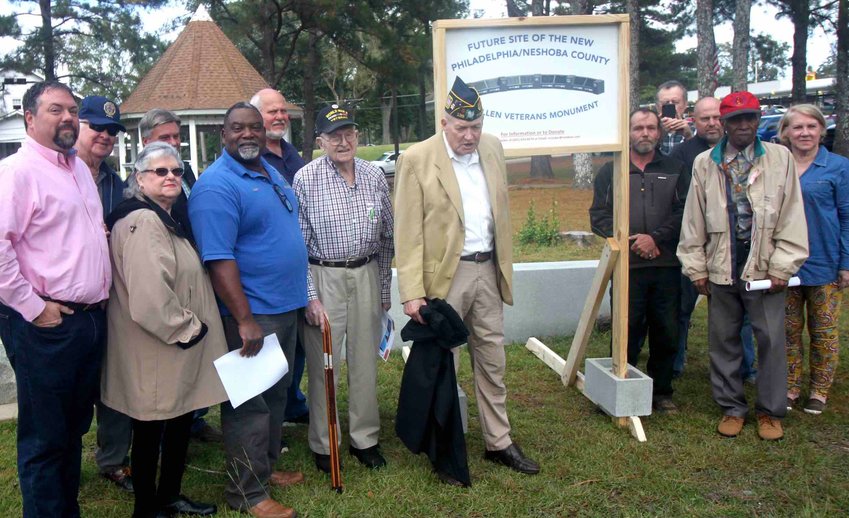 A sign marking where the new Fallen Veterans Monument will be placed was recently unveiled in DeWeese Park. Pictured at the unveiling were, from left, Tim Moore, Madlyn Vuncannon, Tom Vuncannon, Kevin Cumberlain, Obbie Riley, Kevin Cumberland, Keith Lillis, O.D. Jackson, Ray Crocker, William Bradford, Cecil Hooker, Curtis Fancher, Mike Lewis and Pattie Duncan Lee.