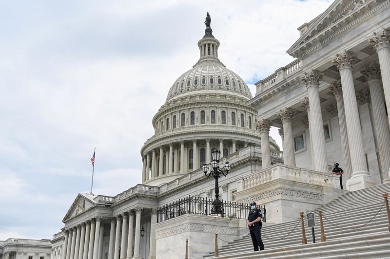 FILE PHOTO: Police officers wearing face masks guard the U.S. Capitol Building in Washington, U.S., May 14, 2020. REUTERS/Erin Scott