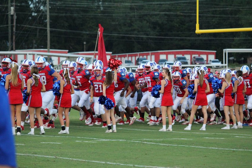 The Neshoba Central Rockets storm the field Friday night in their season opener against Tupelo.
