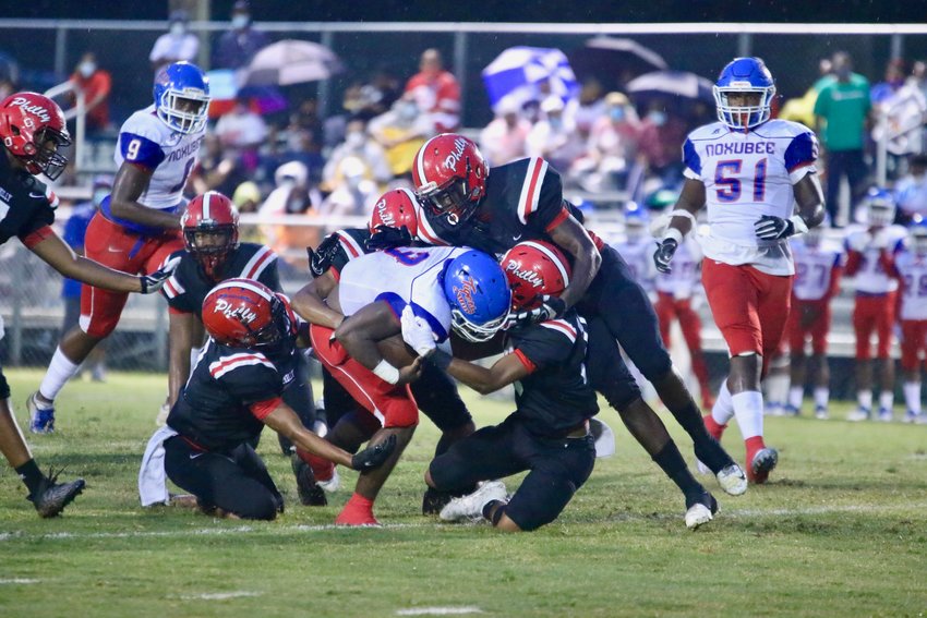Philadelphia's Kornelious Triplett (24) breaks a tackle for a Tornadoes first down. The Philadelphia High School Tornado football team will forfeit its next two games after numerous players have come in close contact with a coach who tested positive for the coronavirus.