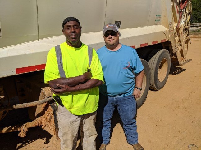 County sanitation workers Sid Whitehead and Tony McIntosh noticed a house on fire last Thursday on County Road 610. Their fast action saved the home.