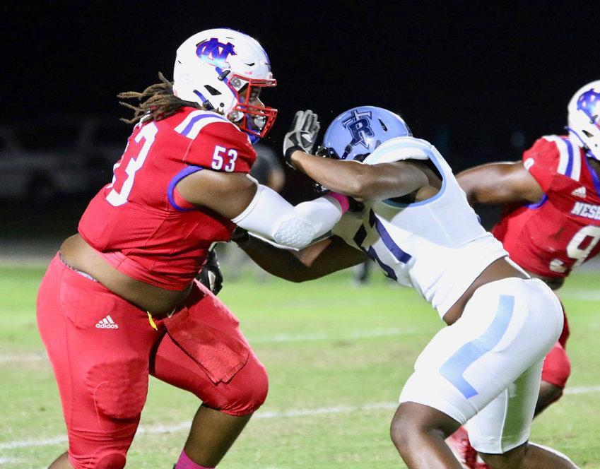 Neshoba Central Maxton Woodward (53) works to get around the Ridgeland offensive line to make a tackle.
