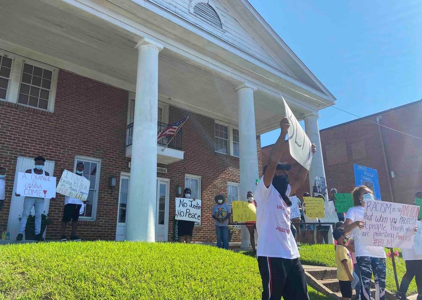 As protestors headed to the courthouse in June, they stopped briefly in front of The Neshoba Democrat to call for “no more bias in their (the Democrat’s) coverage of our community.”