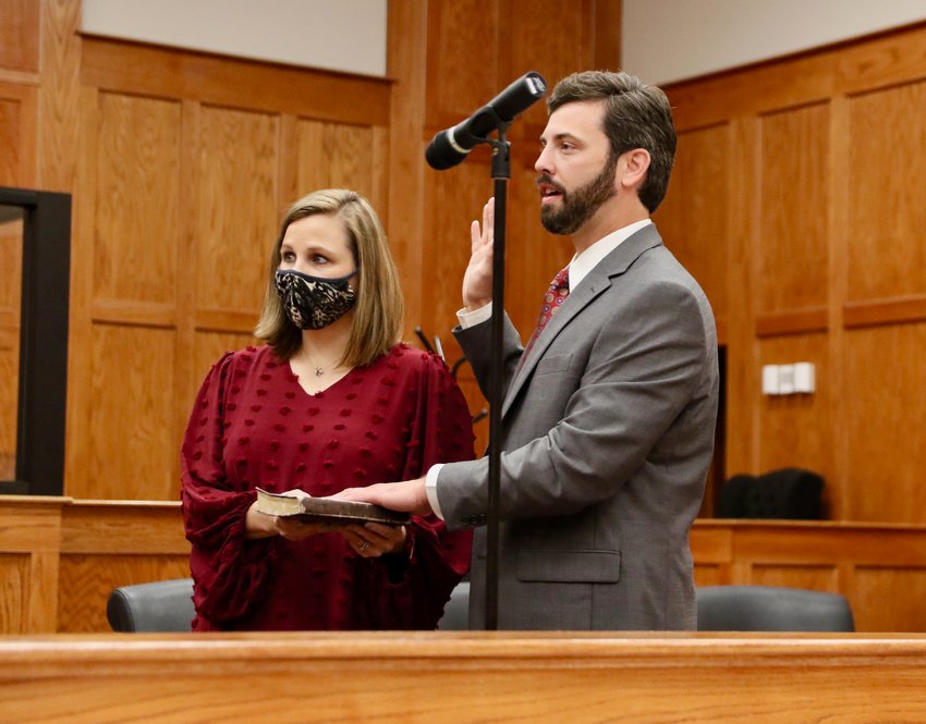 May is sworn in on Wednesday as his wife Natalie holds the Bible. May took nearly 70 percent of the vote in Neshoba County overtaking incumbent Circuit Judge Brian K. Burns in November.