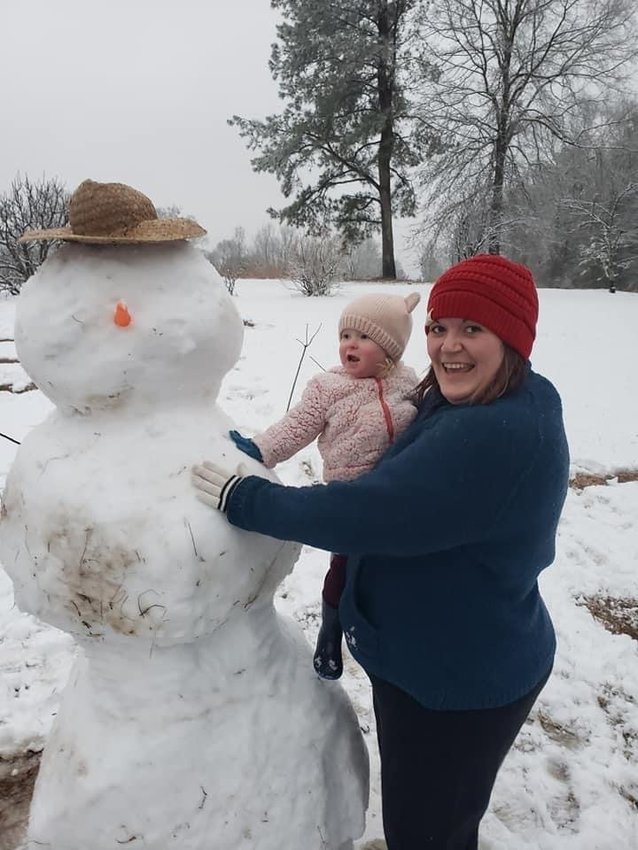 Lucy’s first snow day! Lucy Gillis, 22 months, and her mom and dad, Ryan and Kelly Gillis, making her first snowman!