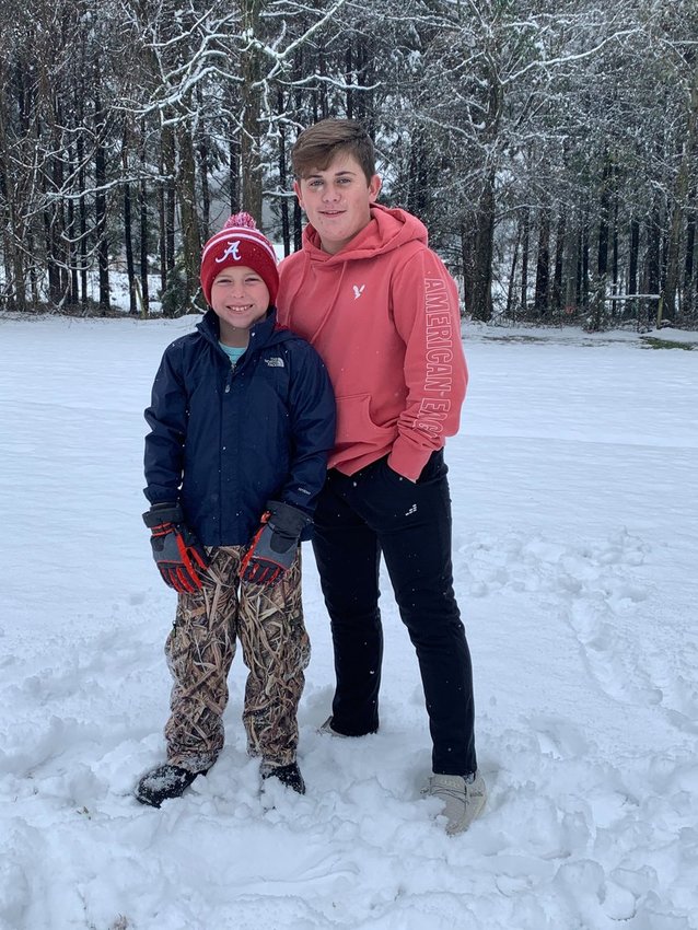 Bryton and Aaron Yates enjoying the snow day by Northside Park.