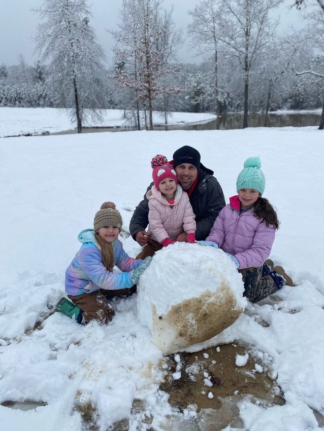 Lexi Pope, Harper Pope, Dustin Pope, and Hallie Cockrell trying to make a snowman
