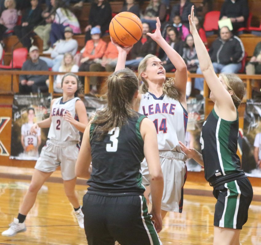 Leake Academy’s Laura Katherine Clair puts up a shot against Manchester Academy on Saturday while Grace Maxie looks on.