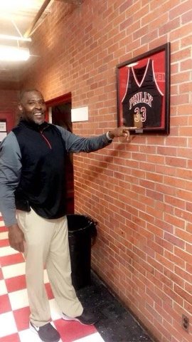 Francisco Wilson Sr. has his high school jersey on the wall at Philadelphia High School.