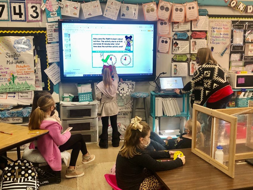 Second grader Charleigh Kate Ridout answers a question on her class’s new Promethean board at the direction of teacher Angie Coward, at right. Promethean boards and other new devices are now in most classrooms across the Neshoba County School District as part of more than $1.5 million in new technology, funded mostly through the first phase of the Mississippi Connects digital learning plan.