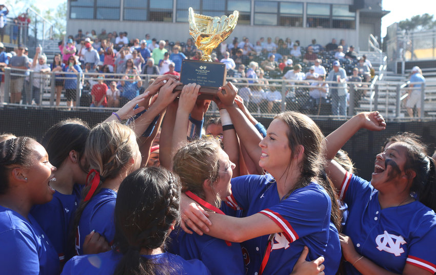 The Neshoba Central Lady Rockets hold up the Class 5A State Softball Championship trophy after beating Moss Point’s East Central Hornets on Friday for their eighth straight title.