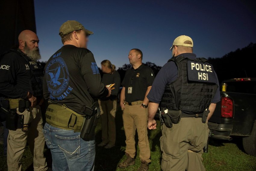 Law enforcement from twelve agencies meet in the early morning hours last Friday for Operation High Life. ICE spokesman Sarah Loicano said that some officers faces have been blurred to protect undercover identities.