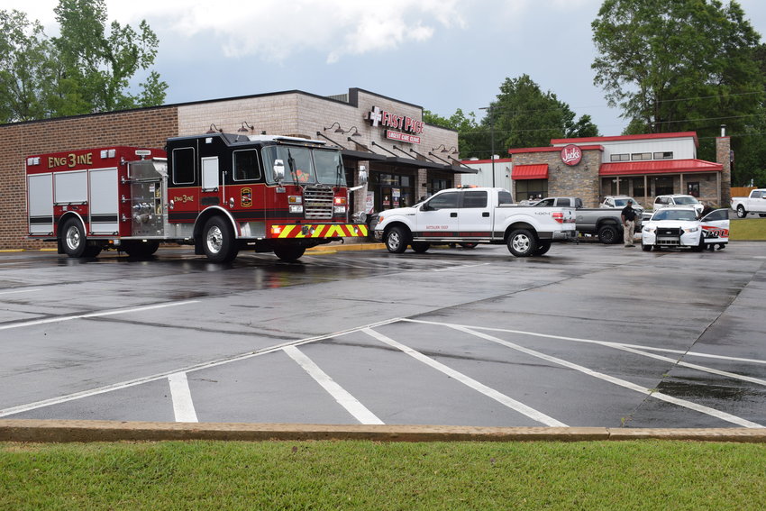 Emergency personnel work at the scene after a car wreck into the Fast Pace Urgent Care building on Wednesday afternoon.