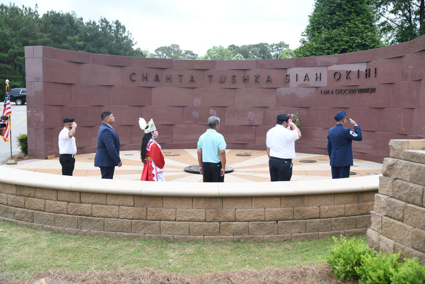 Members of the Choctaw Veterans Color Guard, Tribal Chief Cyrus Ben, 2019-2021 Choctaw Princess Elisah Jimmie, Choctaw Veteran Affairs Director Sammie Wilson, and Chief Master Seargent Ricky Alex gather around the center of the Veterans Memorial to lay the wreath in honor of Memorial Day.