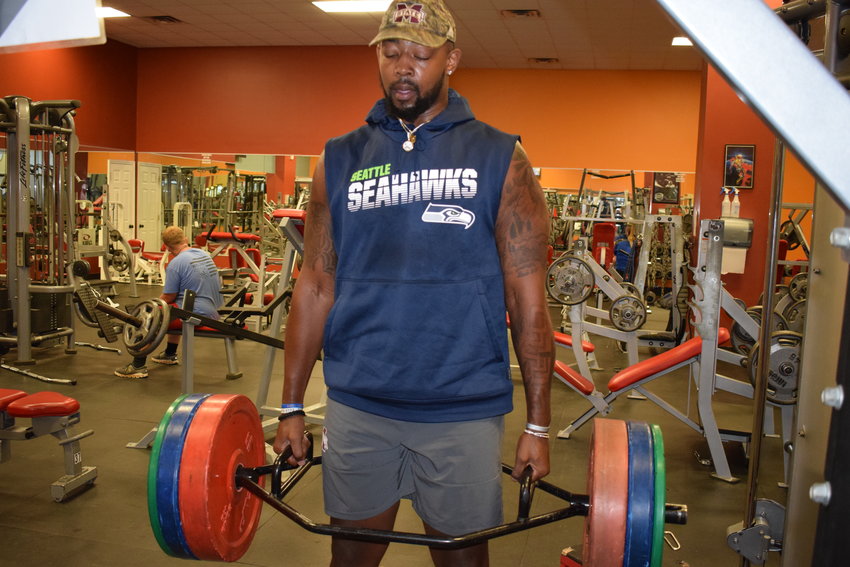 Philadelphia’s Greg Eiland lifts weights at Family Fitness after spending much of the summer at NFL training camp.