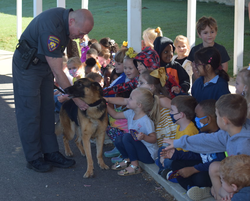 Sgt. Harbert Johnson with the Mississippi Highway Patrol and K-9 Ziva visit with Neshoba Central Elementary School kindergarten students last week for Community Helpers Week. In addition to MHP, students were greeted by firefighters, paramedics, dentists, bankers and more.