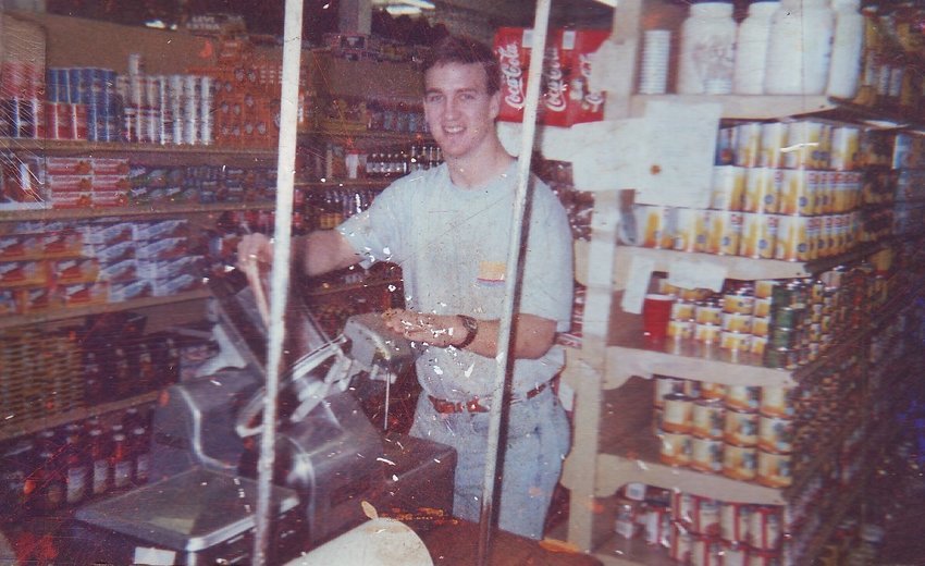 Peyton Manning slicing bacon at the family store as a youth.
