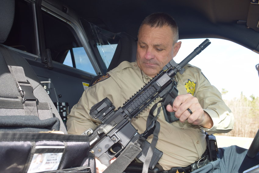 Neshoba County Sheriff Eric Clark locks up an AR-15 patrol rifle in a squad car. The local Masonic Lodge recently donated $3,000 to the Neshoba County Sheriff’s Department to purchase locks for the automatic weapons that previously had to be stored in the trunk.