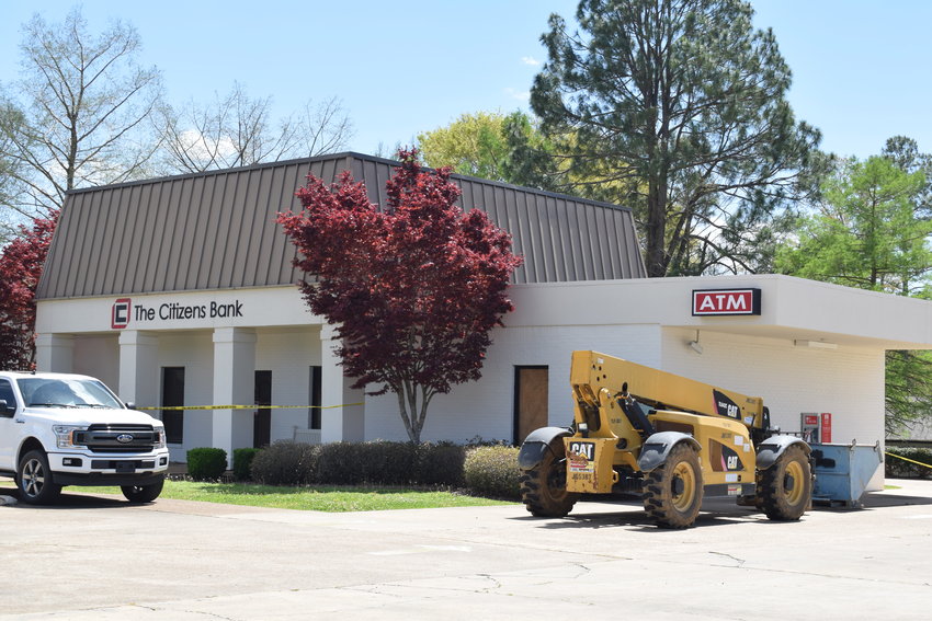 A crane is positioned outside The Citizens Bank branch on east Main Street to repair a collapsed roof.