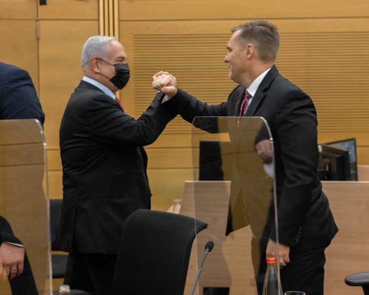 U.S. Rep. Michael Guest, right, bumps fists with former Israeli Prime Minister Benjamin Netanyahu.