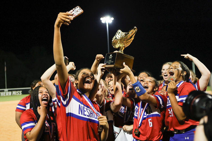 The Lady Rockets take a selfie with the state championship softball trophy