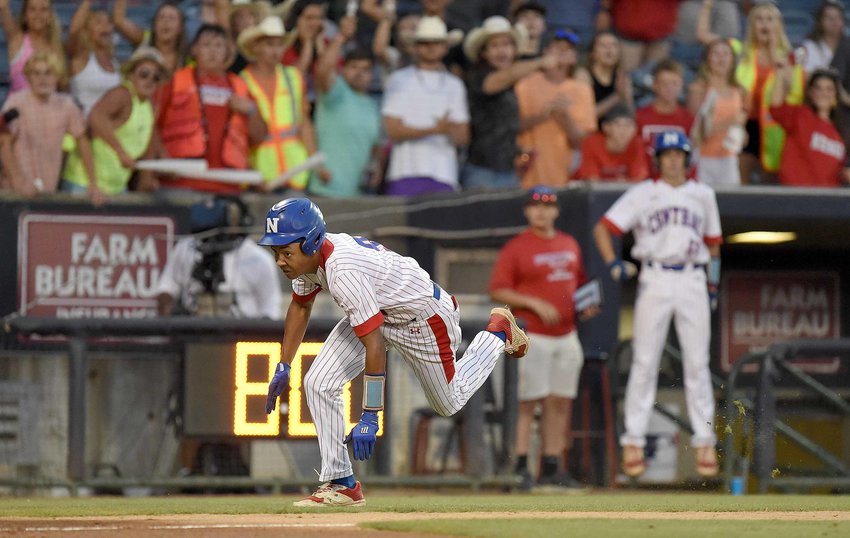 With the crowd cheering him on, Neshoba Central's Jalyas Winters dives for home plate against East Central at the MHSAA Baseball State Championship on Thursday, May 26, 2022, at Trustmark Park in Pearl, Miss.