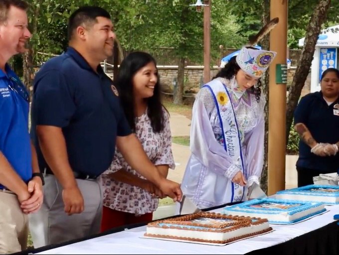 Tribal Chief Cyrus Ben, center, cuts a birthday cake for Geyser Falls which recently celebrated being open for 20 years.