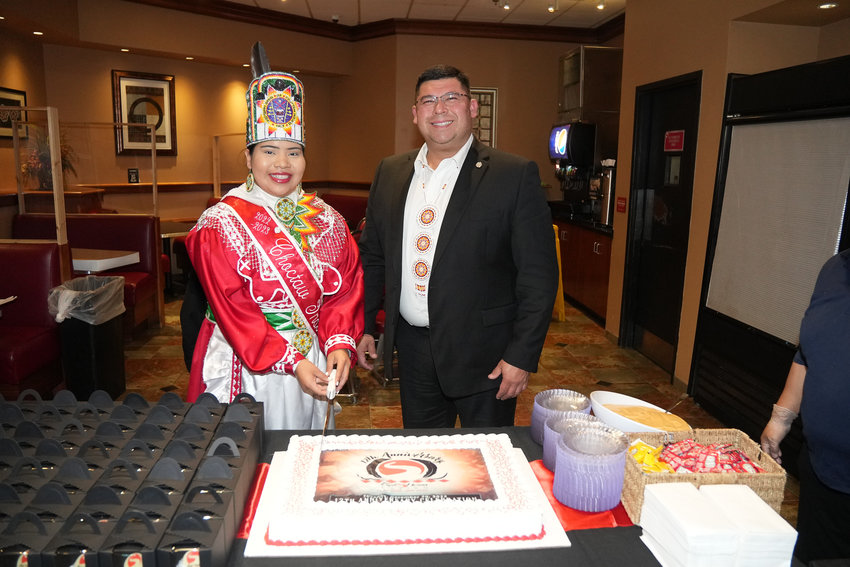 Tribal Chief Cyrus Ben, right, and Choctaw Indian Princess-Cadence Nickey get ready to slice the cake.