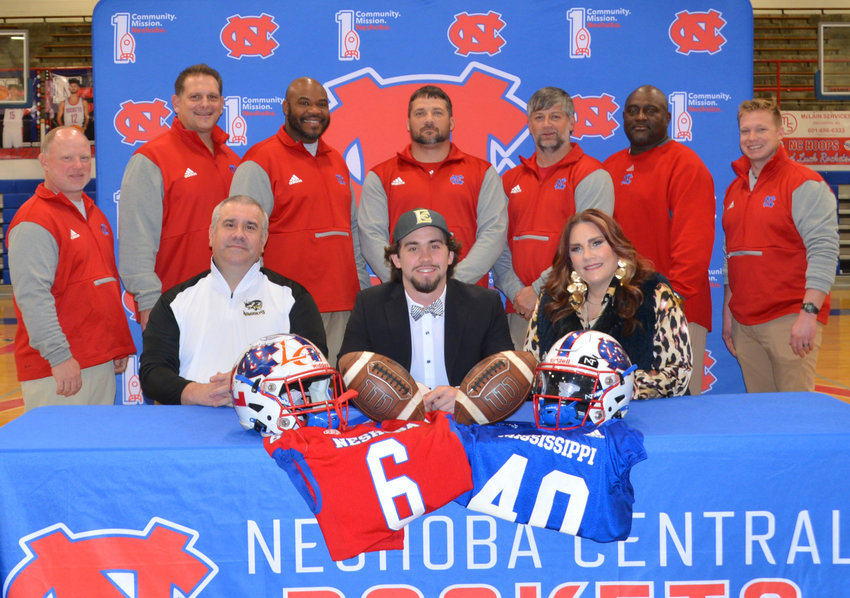 Pictured, seated from left, are his father, Adrian Holley, Beau Holley and his mother Lori Holley (Back) Coach David Huffman, Coach Brian Anderson, Coach Shannon Ruffin, Head Coach Patrick Schoolar, Coach Curtis Blackburn, Coach Daryl Carter, and Coach Jacob Johnson.