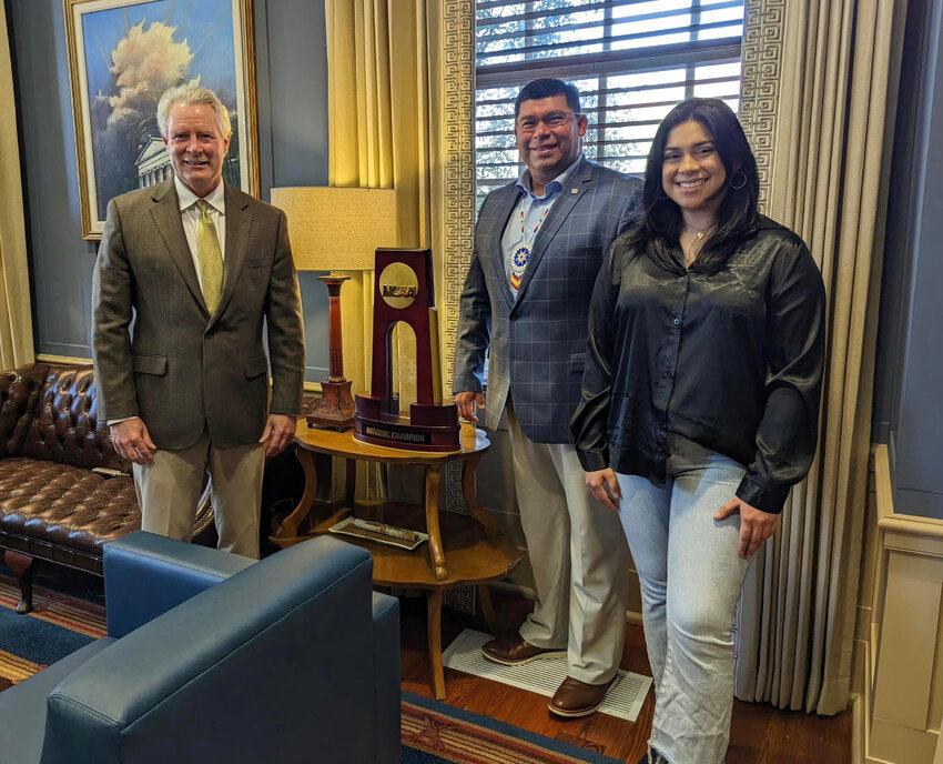 Kara Edwards, right, stands with Tribal Chief Cyrus Ben, center, and Ole Miss Chancellor Glenn Boyce, left. Edwards received the first-ever Indigenous Space Law Scholarship at the University last month, which will give her a full ride through her final year of law school. The scholarship is valued at over $25,000.
