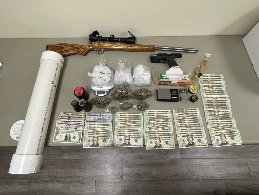 Money, fired rms and drugs and other paraphernalia seized during the raid.