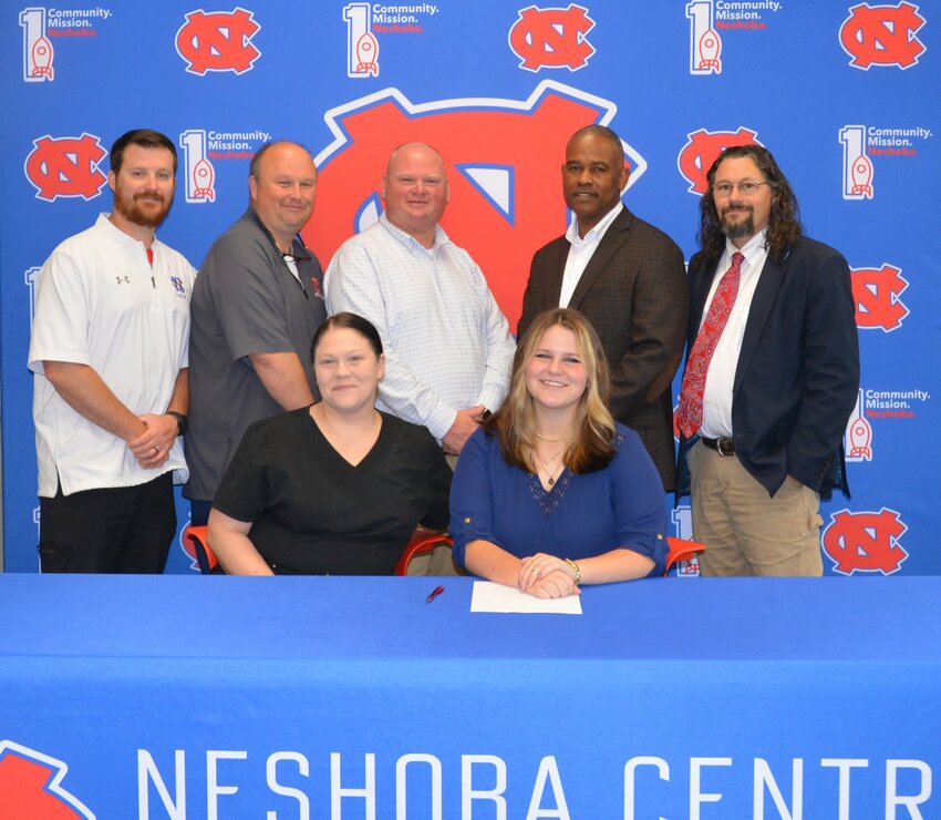Neshoba Central’s Lylanna Myers signed with East Mississippi Community College to further her education and be a member of the EMCC Band. Pictured, from left, are her mother Vickie Collins and Lylanna Myers (Back) Assistant Principal Jonathan Walker,  Principal Jason Gentry, Assistant Principal Brent Pouncy Assistant Principal LaShon Horne, and Band Director Daniel Wade.