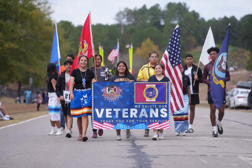 On Thursday, Nov. 9, the Mississippi Band of Choctaw Indians held activities to commemorate Veterans Day and to honor all those who have served the Tribe and their country in the United States armed forces. In the afternoon, a Veterans Day parade was held along a stretch of Blackjack Road in the Pearl River community, starting from the Choctaw Sportsplex and ending at the Choctaw Veterans Memorial. Over 20 entries participated in this year’s parade, including Tribal Chief Cyrus Ben and the Tribal Administration, 2023-2024 Choctaw Indian Princess Nalani LuzMaria Thompson, Pearl River Resort, Tribal departments, programs, schools, and other organizations. Parade Grand Marshals were Tribal Veterans Sergeant (Ret.) Benny Thompson and Specialist (Ret.) Mary Helen Umholtz. Following the parade, a ceremony was held at the site of the Choctaw Veterans Memorial. Princess Nalani Thompson served as mistress of ceremonies, and remarks were given by Chief Ben and guest speaker Sergeant Major (Ret.) Barry Parker.