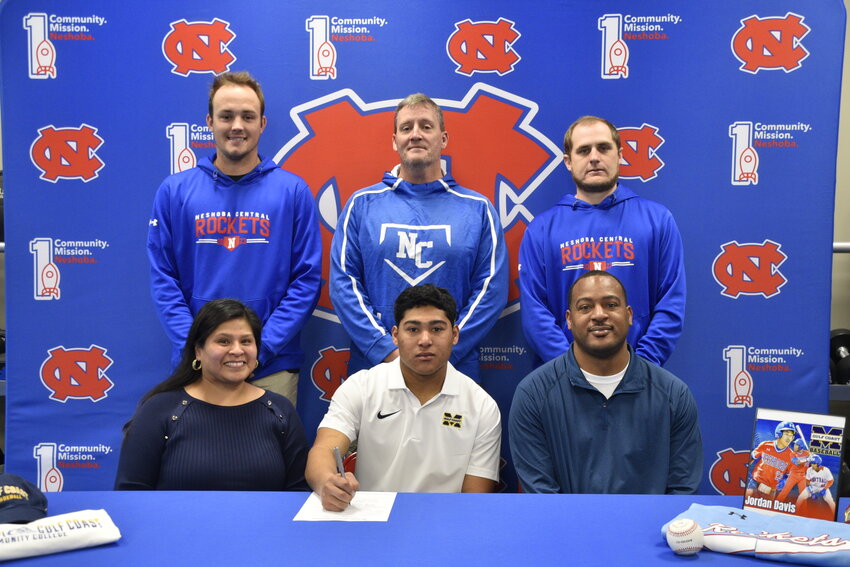Pictured seated, from left, are his mom, Rhea Thomas, Jordan Davis, and his dad, Tywon Davis. (Back) Assistant Coach Tanner Jones, Head Coach Jonathan Jones, and Assistant Coach Kip Fulton.